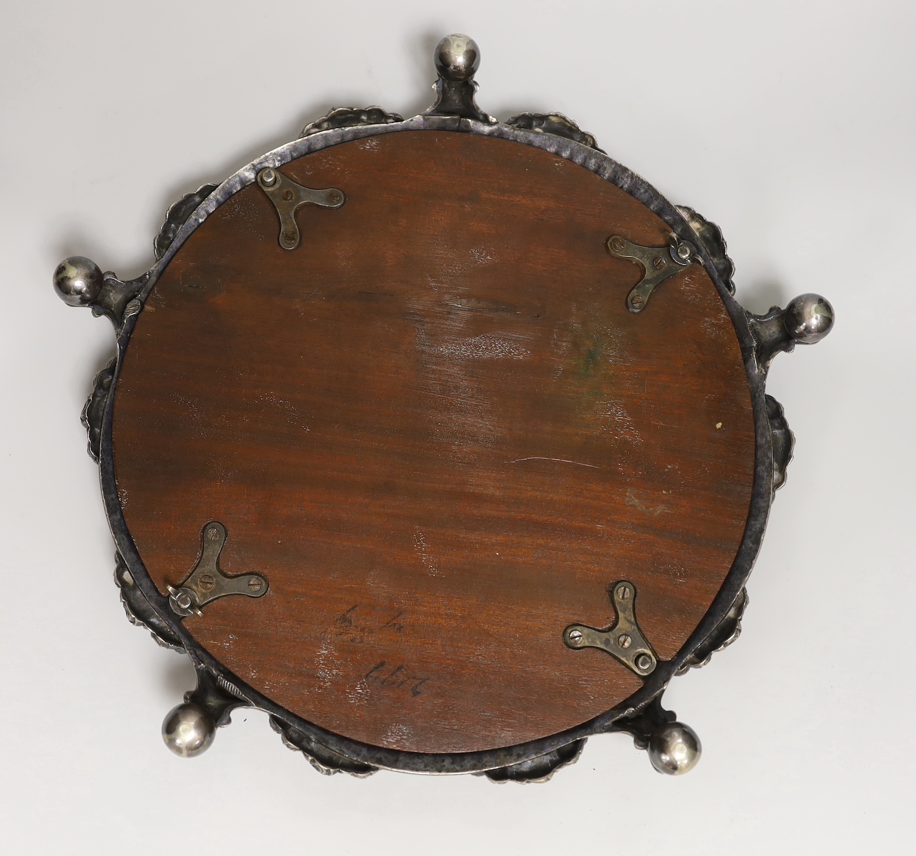 An electroplate mirrored plateau or cake stand decorated with lions and swags, 36cm in diameter